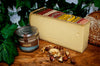 Wedge of Comte AOP 18 months French Cheese on a cheeseboard.