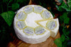 Cremeux de Bourgogne Triple cream French Cheese on a cheeseboard, full wheel and a wedge, view from above