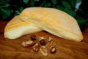 Reblochon du Jura French Cheese on a cheeseboard. Two Half wheel