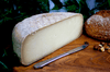 Ossau Iraty Half wheel French AOP Cheese on a cheeseboard. 