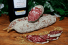 Pastis Saucisson Sec. Aged French Salami made with Free Range Pork on a chopping board with fennel seed.